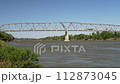traffic on a truss bridge over the Missouri River at Brownville, Nebraska, windy early fall scenery 112873045
