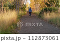 male cyclist riding a touring gravel bike on a trail in northern Colorado in fall scenery 112873061