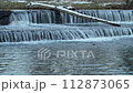 Water cascading over a diversion dam on the Poudre River with fall scenery in Fort Collins, Colorado, nature and industry concept 112873065