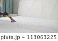 Cleaning the mattress with a professional vacuum cleaner using detergent 113063225