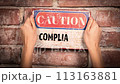 Compliance concept. Caution sign with text on brick wall background 113163881