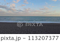 Walk along the shore with waves after sunset 113207377