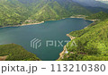Aerial view of a lava flow created volcanic lake surrounded by thick forest and mountains (Saiko) 113210380