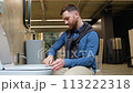 In a plumbing store. A man chooses a new toilet bowl 113222318