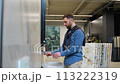 Handsome man choosing new bathroom furniture at luxury plumbing shop 113222319