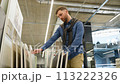 A man choosing ceramic tiles for his house in luxury shop 113222326