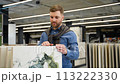 Handsome man chooses tiles in luxury shop 113222330