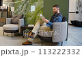 Handsome man chooses tiles on the catalog in luxury shop 113222332