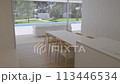 House with dining area, hardwood table and chairs, overlooking a swimming pool 113446534