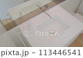 Plumbing fixture with tap, sink, and mirror on bathroom countertop 113446541