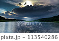 Sunbeams through thunderclouds over the river 113540286