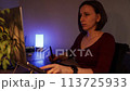 Young woman using a laptop and graphic tablet at home in the evening 113725933