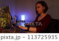 Young woman using a laptop and graphic tablet at home in the evening 113725935