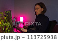 Young woman using a laptop and graphic tablet at home in the evening 113725938