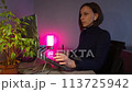 Young woman using a laptop and graphic tablet at home in the evening 113725942