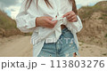 Woman dressed in country style posing in the summer field 113803276