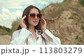 Woman dressed in country style posing in the summer field 113803279