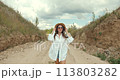 Woman dressed in country style posing in the summer field 113803282