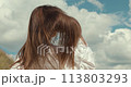 Young Caucasian woman dressed in cowboy style in the summer field 113803293