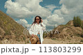 Woman dressed in country style posing in the summer field 113803299