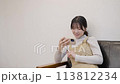 Young woman watching a video on her smartphone 113812234