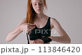 female athlete, sportswoman concentrated on putting on bandage 113846420