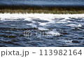The flow of water from the outlet of an artificial dam 113982164