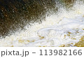 The flow of water from the outlet of an artificial dam 113982166