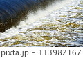 The flow of water from the outlet of an artificial dam 113982167