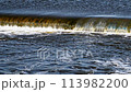 The flow of water from the outlet of an artificial dam 113982200