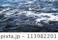 streams of water seethe in powerful waterfall, Foam floating in flowing river water 113982201