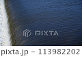 The flow of water from the outlet of an artificial dam 113982202