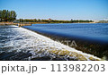 The flow of water from the outlet of an artificial dam 113982203