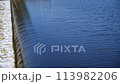 The flow of water from the outlet of an artificial dam 113982206
