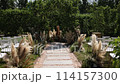 a beautiful arch for a wedding ceremony in a park with chairs	 114157300