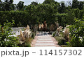 a beautiful arch for a wedding ceremony in a park with chairs	 114157302