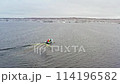 Fishermen Navigating Fish Farm Cages. Aerial drone shot 114196582