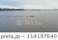 Winter Fish Farm Patrol. Anglers sail an iron motorboat on an open water fish farm in winter through snow-covered scenery. Aerial drone shot 114197640