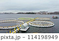 Organic Aquaculture Unveiled: Snow-Adorned Salmon and Trout Farms. Aerial drone shot 114198949