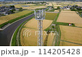 A mobile phone tower standing in a rural landscape. A pan-down video of the entire tower. 114205428