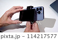 a tech blogger makes a video review on a smartphone and a screen broadcast display 114217577