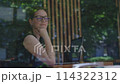 Seated in cafe woman freelancer diligently works on laptop looking through window. Looking through window moment freedom introspection of modern freelancing Woman looking through window. 114322312