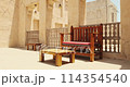 old Arab bench. Wooden bench. Arabic benches. Ancient Middle East. Sofa in Arabic style in house. Resting place in an Arab house. Moroccan style. Traditional arabic bench in the streets of old Dubai 114354540