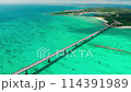 沖縄県宮古島の宮古ブルーの海と橋をドローンからの空撮映像 114391989