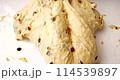 Confectioner kneads dough with raisins for baking a cupcake 114539897