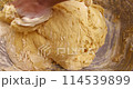 Confectioner kneads dough for baking dough 114539899