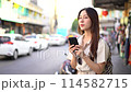 Smiling Asian woman traveller backpacker using application of taxi service app on smart phone. High quality 4k footage 114582715