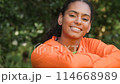 Beautiful mixed race African American girl biracial teenager young woman outside smiling and laughing outside in a park 114668989