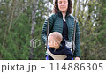 Caucasian Baby Boy on a swing with mother. Park Outside 114886305