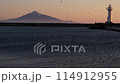 View of the sea at dusk, the lighthouse and Rishiri Island. 114912955